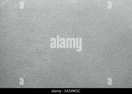 Gray cardboard texture, close-up. Neutral, rough surface with visible grain  natural imperfections. Ideal for backdrops, packaging or design project Stock Photo
