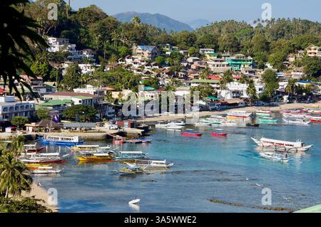 Boats are moored in the main Sabang Bay of PUERTO GALERA, the PHILIPPINES Stock Photo