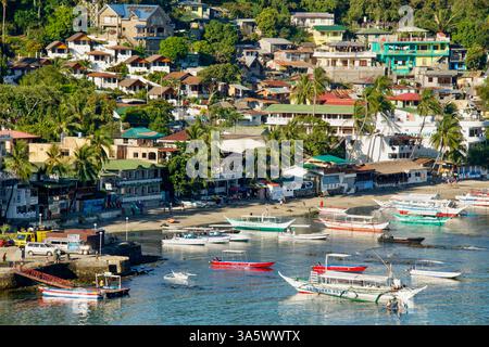 Boats are moored in the main Sabang Bay of PUERTO GALERA, MINDORO ISLAND, the PHILIPPINES Stock Photo