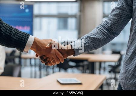 Close up view of handshake between two business partners in the office. Stock Photo