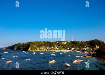 Boats are moored in the main Sabang Bay of PUERTO GALERA, the PHILIPPINES Stock Photo