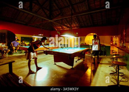 Local residents enjoy a game of pool at the local billiards hall in Sabang, PUERTO GALERA, the  PHILIPPINES Stock Photo