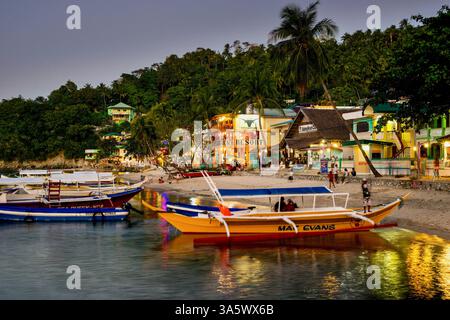 Boats are moored in the main Sabang Bay of PUERTO GALERA, on Mindoro Island, the PHILIPPINES Stock Photo