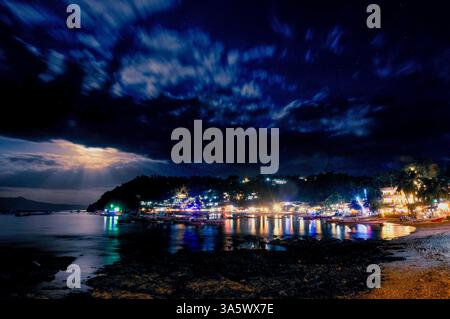 Boats are moored in the main Sabang Bay of PUERTO GALERA, on Mindoro Island, the PHILIPPINES Stock Photo