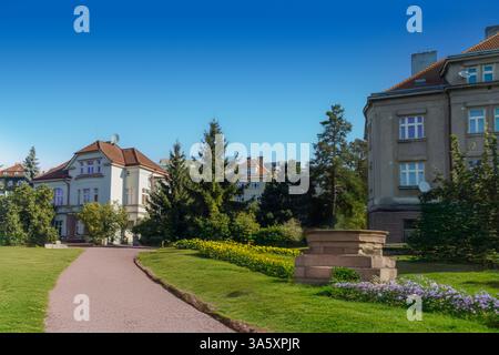 Prague cottage garden gravel path with lavender border and houses in the background. Prague. Czech Republic Stock Photo