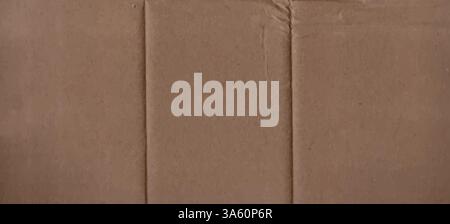 Crumpled horizontal cardboard texture. Abstract brown background with wrinkled paper texture. Vector illustration of a kraft folded and then unfolded Stock Vector