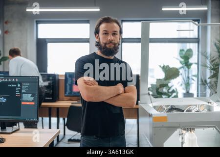 Man is in the office with 3d printer. Stock Photo