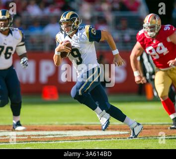 St. Louis Rams quarterback Austin Davis rolls out to pass the football ...