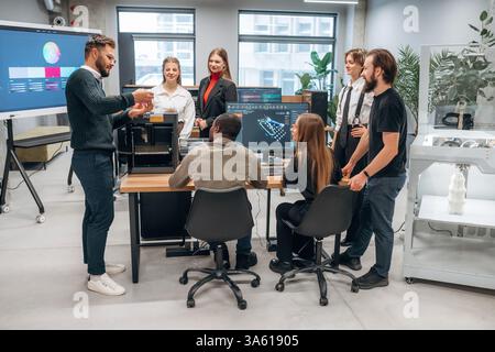 3d printer is on the table. Designer team are together in the office. Stock Photo