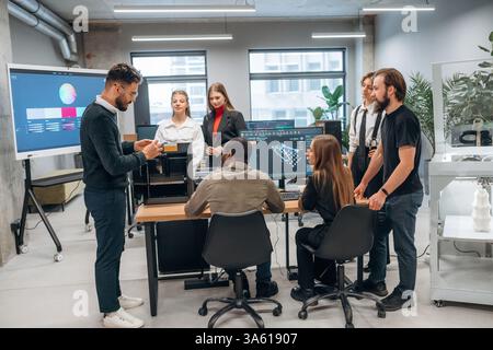 3d printer is on the table. Designer team are together in the office. Stock Photo