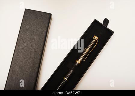 A gift pen in a box. A black fountain pen. Stock Photo