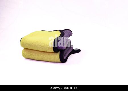 Stack of Folded Yellow and Gray Microfiber Cloths Stock Photo