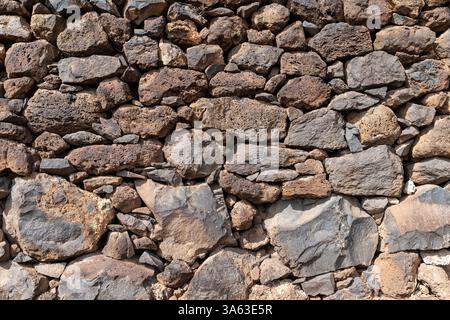 Stone Wall Made of Varied Sizes and Shapes of Stones Stock Photo