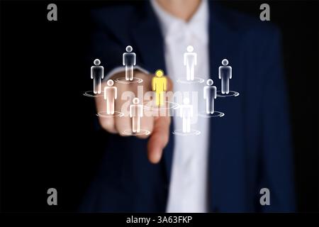 Targeting, recruitment, customer acquisition. Business woman touching virtual screen with human icons against black background, closeup Stock Photo