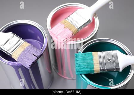 Cans of paint and brushes on grey background, closeup Stock Photo