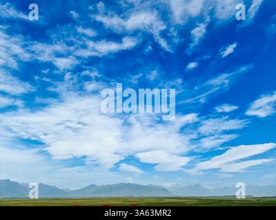 Stunning lenticular cloudscape over a green valley and mountain range in Iceland, creating a picturesque landscape Stock Photo