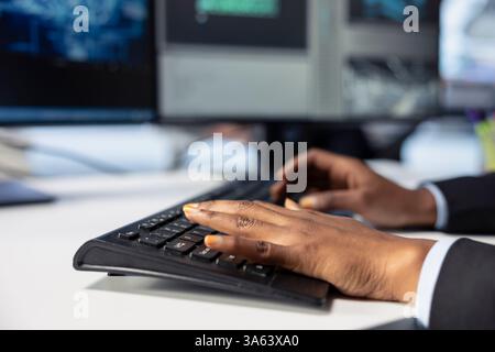 Photovoltaics factory engineer programming AI tools, typing on keyboard, developing solutions to detect errors. Close up of expert writing code, using machine learning to prevent equipment failures Stock Photo