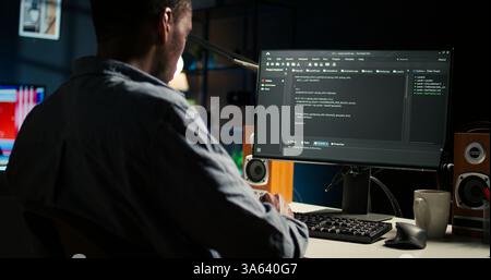 Black man programmer manages code and scripts in artificial intelligence and machine learning on dual monitors computer setup. Male freelancer uses pc to guarantee cyber security. Camera A. Stock Photo