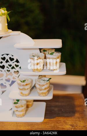 Appetizing looks more cakes in cups on a white stand at the holiday Stock Photo