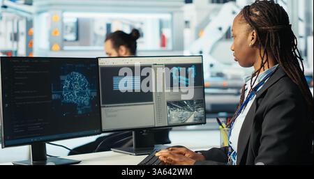 Photovoltaics factory programmer using AI technology to monitor system performance. Solar panels manufacturing plant developer using artificial intelligence to track energy production, camera B Stock Photo