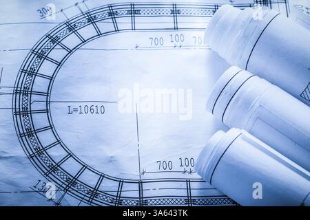 Rolled up construction plans on blueprint top view Stock Photo