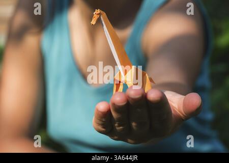 Origami orange color giraffe on hand Stock Photo