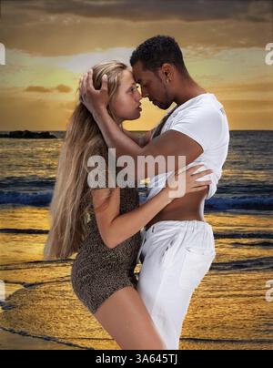 Young couple dancing near the ocean at sunset Stock Photo