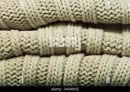 Old knit sweater background. Beige color. Studio shot Stock Photo