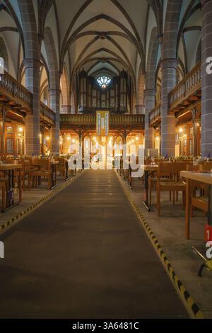Central passageway in a church with covered tables on both sides, Vesperkirche Calw, Black Forest, Germany, Europe Stock Photo