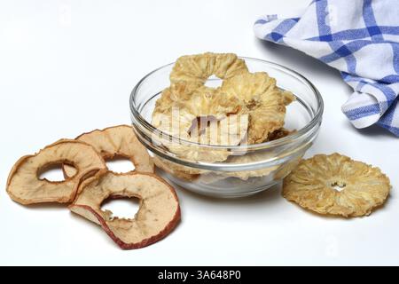 Dried pineapple slices in peel and dried apple rings, dried fruit Stock Photo