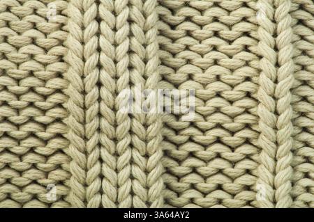 Old knit sweater background. Beige color. Studio shot Stock Photo