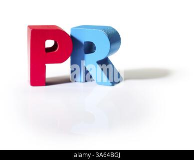 Multicolored text PR made of wood. White background Stock Photo