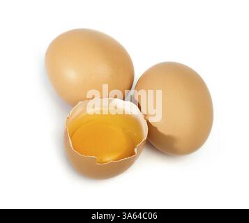 Tree whole eggs and another broken in half raw egg and yolk inside. Placed on white background Stock Photo