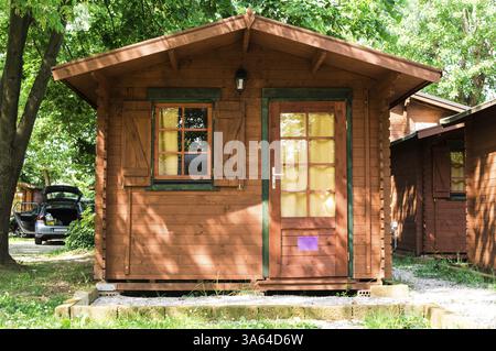Wooden bungalows on campsite camping. Green trees Stock Photo