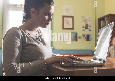 Student girl and laptop in a vintage library Stock Photo