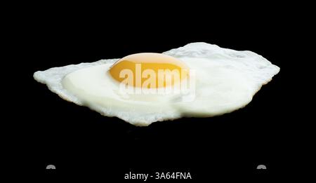 Fried egg on black background Stock Photo