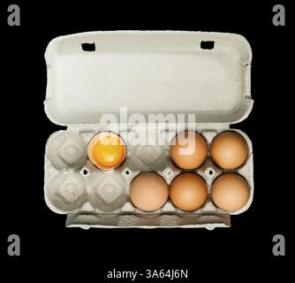 Eggs box and aggs inside. Isolated on black background.Broken egg in a carton Stock Photo