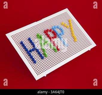 Text Happy on child mosaic. Colorful mosaic pieces Stock Photo