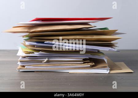 Stack of different paper envelopes on wooden table, closeup. Post office Stock Photo