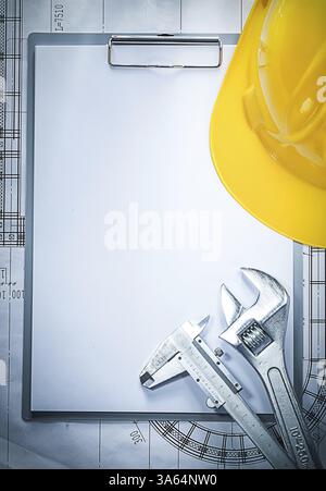 Clipboard building helmet adjustable spanner vernier caliper on blueprint Stock Photo