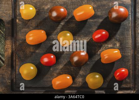 Variety of cherry tomatoes on wood. Multicolored tomatoes Stock Photo