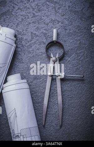 Rolled blueprints divider on black background maintenance concept Stock Photo