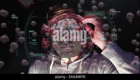 Analyzing virus data on digital interface, man in hoodie with focused expression Stock Photo