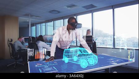 In modern office, man using VR headset interacting with 3D car model on screen Stock Photo