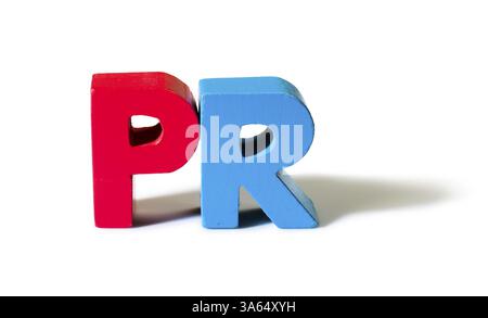 Multicolored text PR made of wood. White background Stock Photo