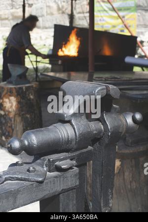 Vise and anvil in a forge shop. Blacksmith tools Stock Photo