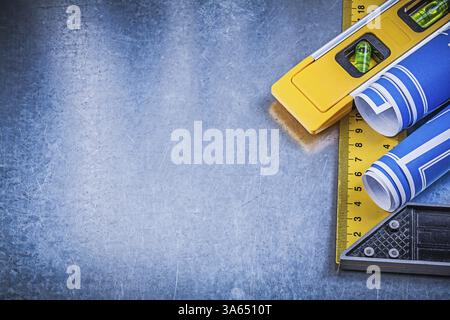Blue blueprints construction level square ruler on metallic background ...