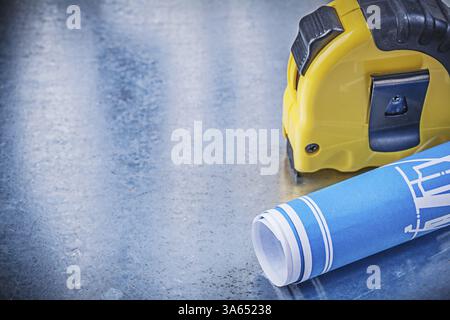Blue engineering drawings tape measure on metallic background construction concept Stock Photo
