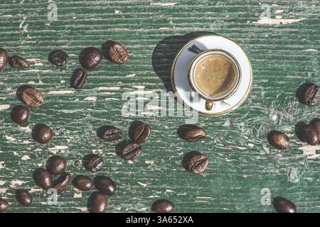Cup of coffee on wooden table. Small miniature cup Stock Photo