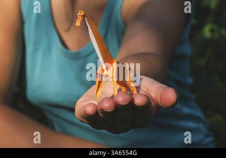 Origami orange color giraffe on hand Stock Photo